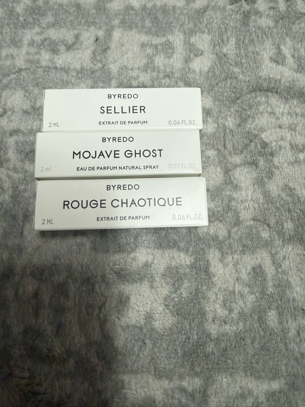 Byredo sample trio — white boxes with red, clear, and amber vials